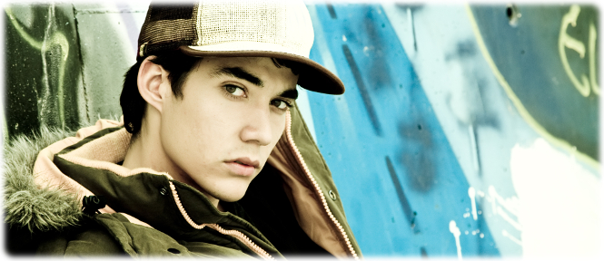 Portrait of a young man in a ball cap.